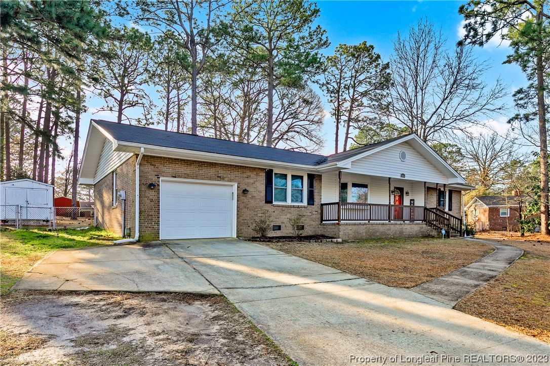 6433 Milford Road Fayetteville, NC 28303 - Photo 3 of 46 a front view of a house with a yard and garage