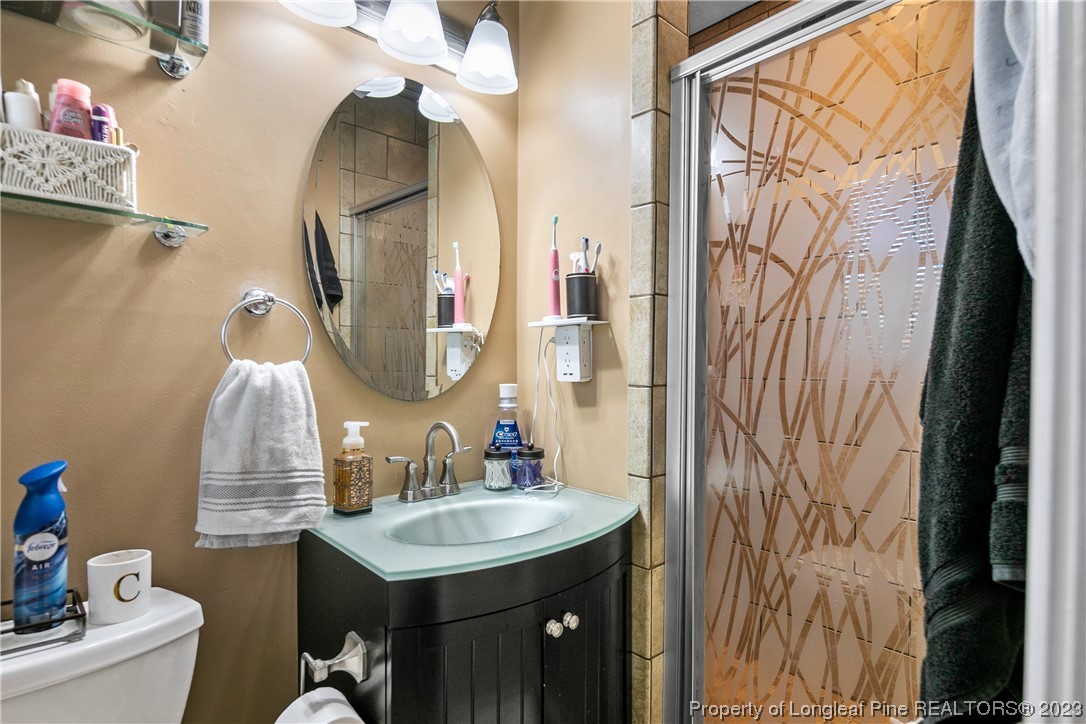 6433 Milford Road Fayetteville, NC 28303 - Photo 31 of 46 a bathroom with a sink vanity and a mirror