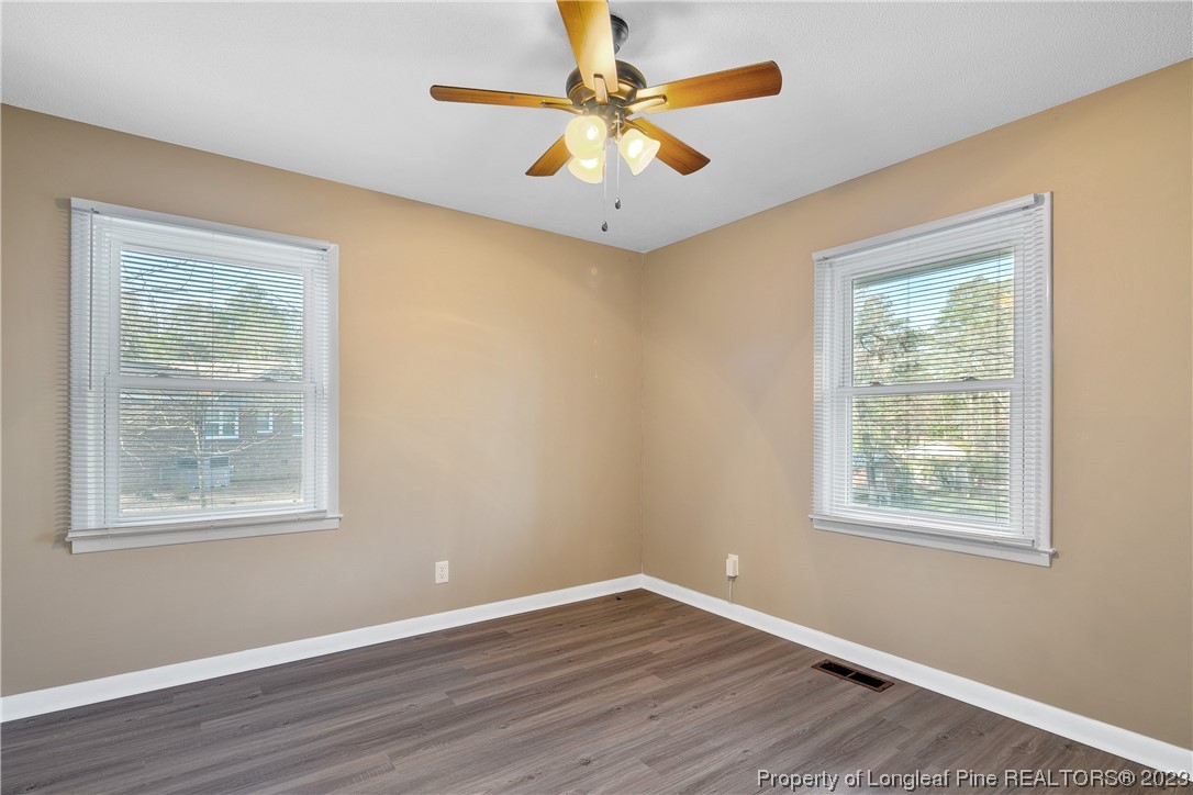 6433 Milford Road Fayetteville, NC 28303 - Photo 32 of 46 a view of an empty room with window and wooden floor