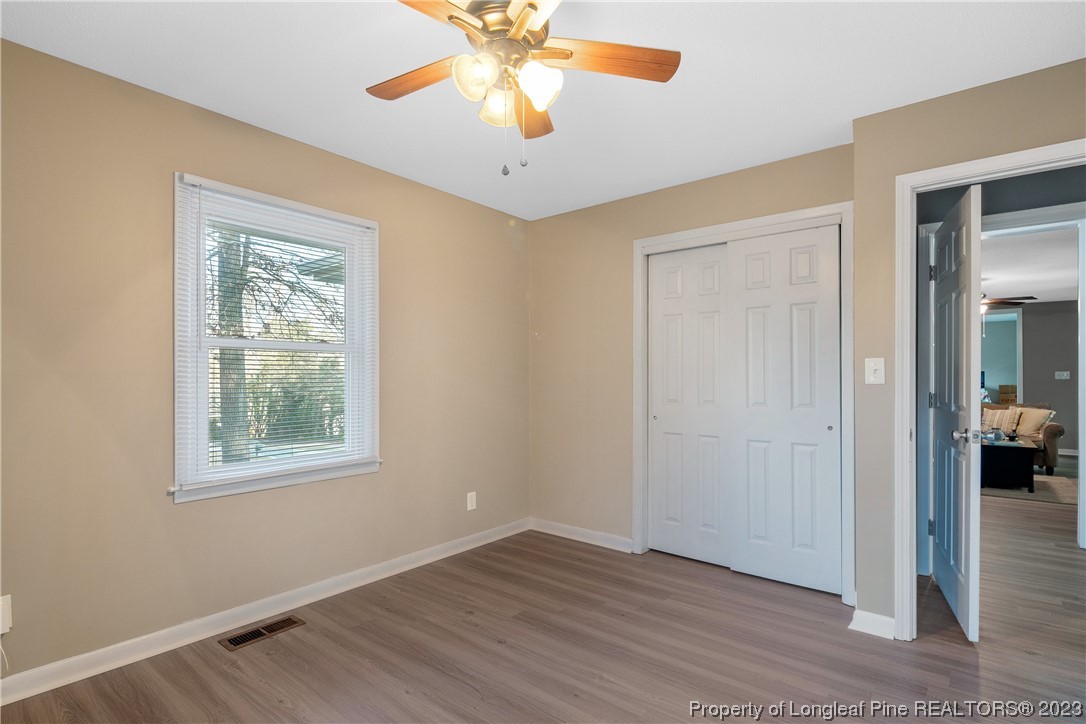 6433 Milford Road Fayetteville, NC 28303 - Photo 33 of 46 a view of an empty room with window and wooden floor