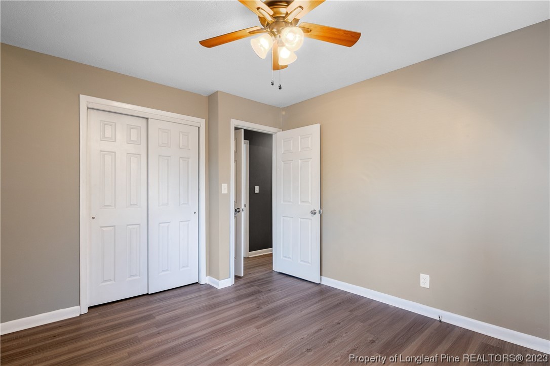6433 Milford Road Fayetteville, NC 28303 - Photo 34 of 46 a view of an empty room with window and wooden floor