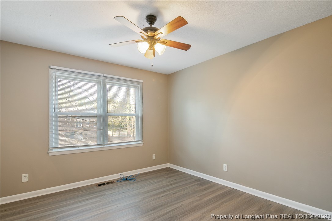 6433 Milford Road Fayetteville, NC 28303 - Photo 39 of 46 an empty room with windows and fan