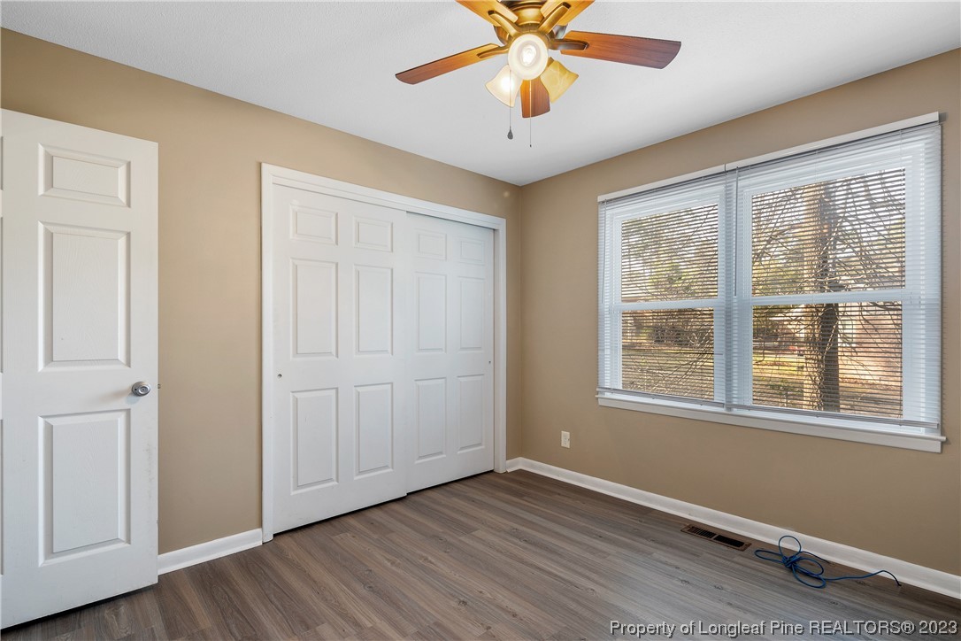 6433 Milford Road Fayetteville, NC 28303 - Photo 42 of 46 a view of an empty room with a window and wooden floor