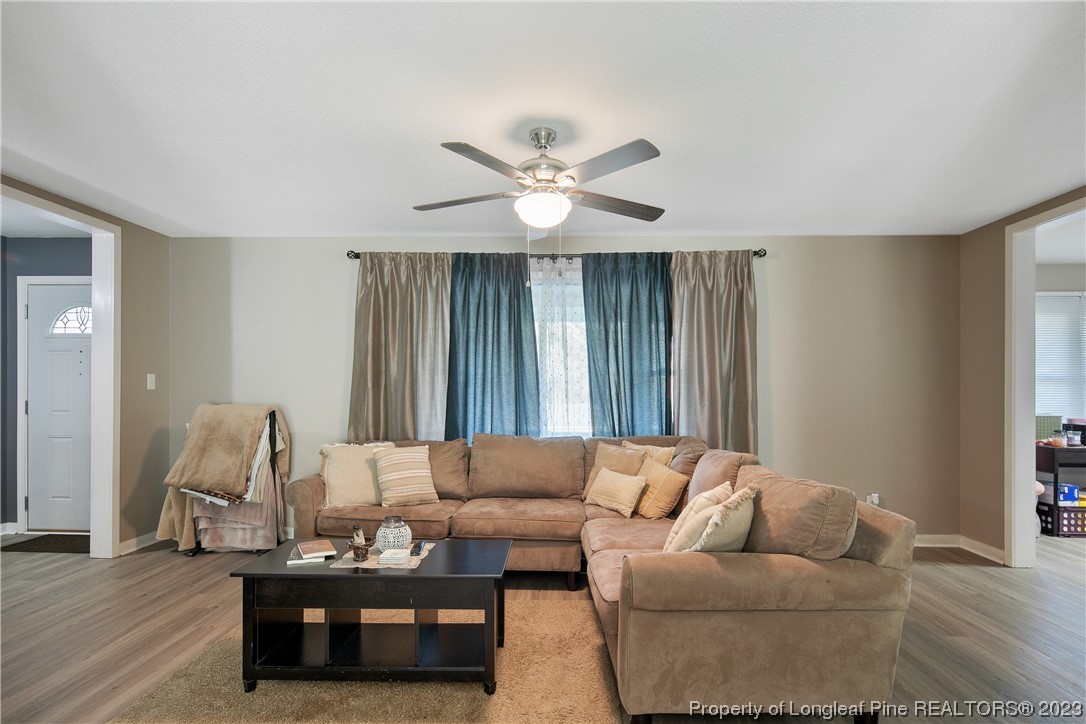6433 Milford Road Fayetteville, NC 28303 - Photo 10 of 46 a living room with furniture and wooden floor