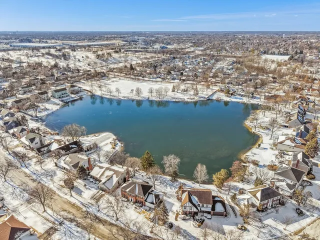 an aerial view of a house with a lake view