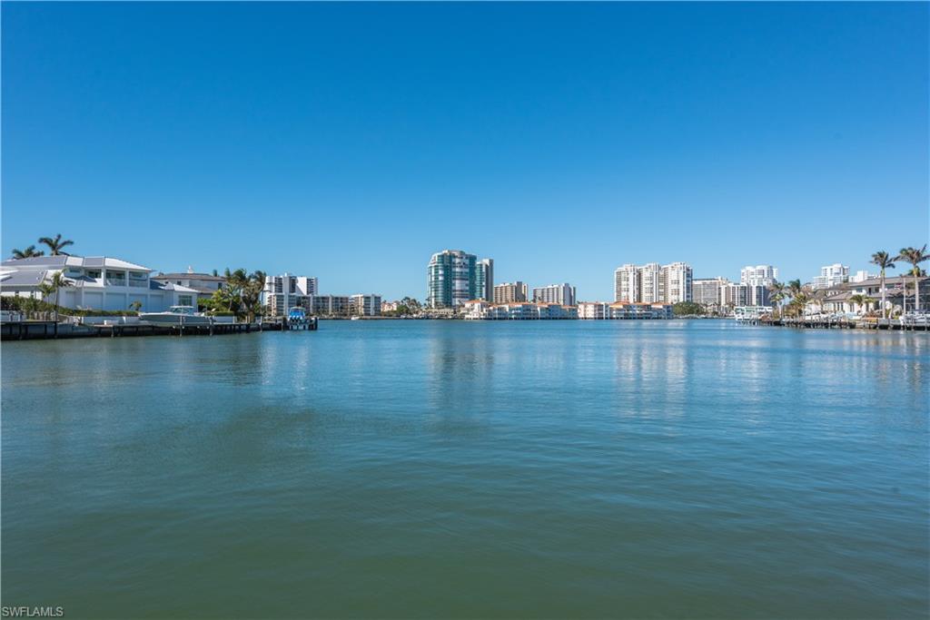 3453 Crayton Road Naples, FL 34103 - Photo 3 of 5 a view of a ocean with boats and trees in the background