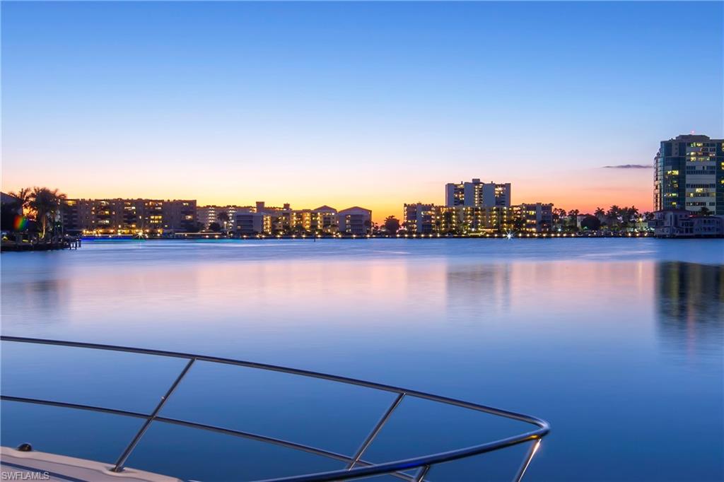 3453 Crayton Road Naples, FL 34103 - Photo 4 of 5 a view of a lake with houses