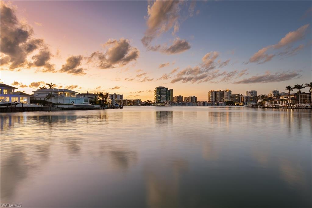 3453 Crayton Road Naples, FL 34103 - Photo 5 of 5 a view of a lake with houses in the back