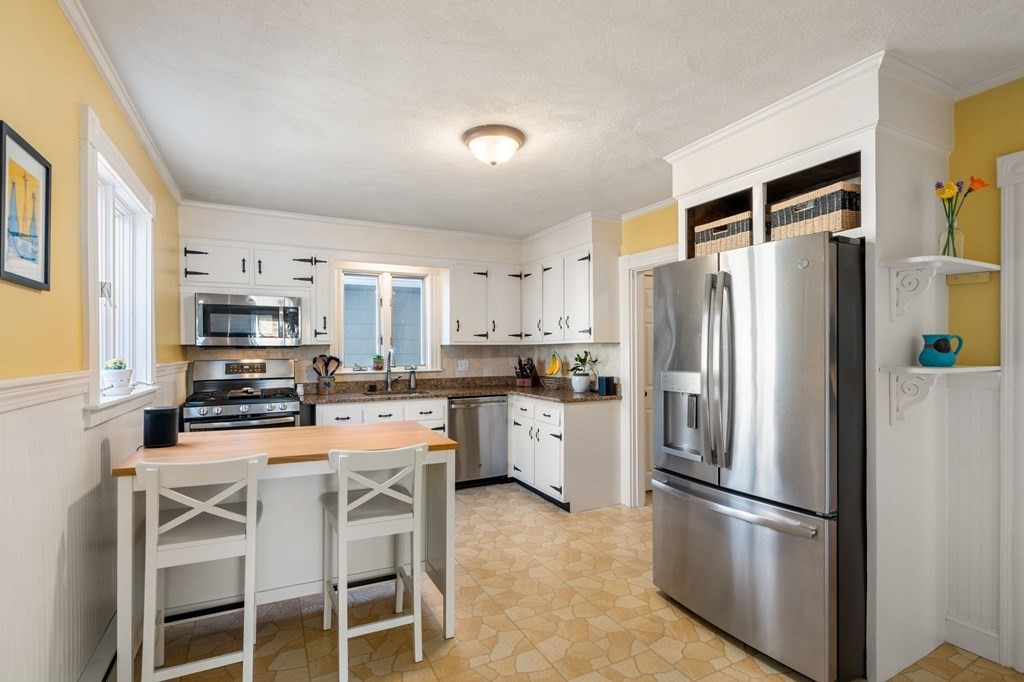 11 Spring Lane Maynard, MA 01754 - Photo 16 of 39 a kitchen with stainless steel appliances granite countertop a refrigerator stove microwave and sink