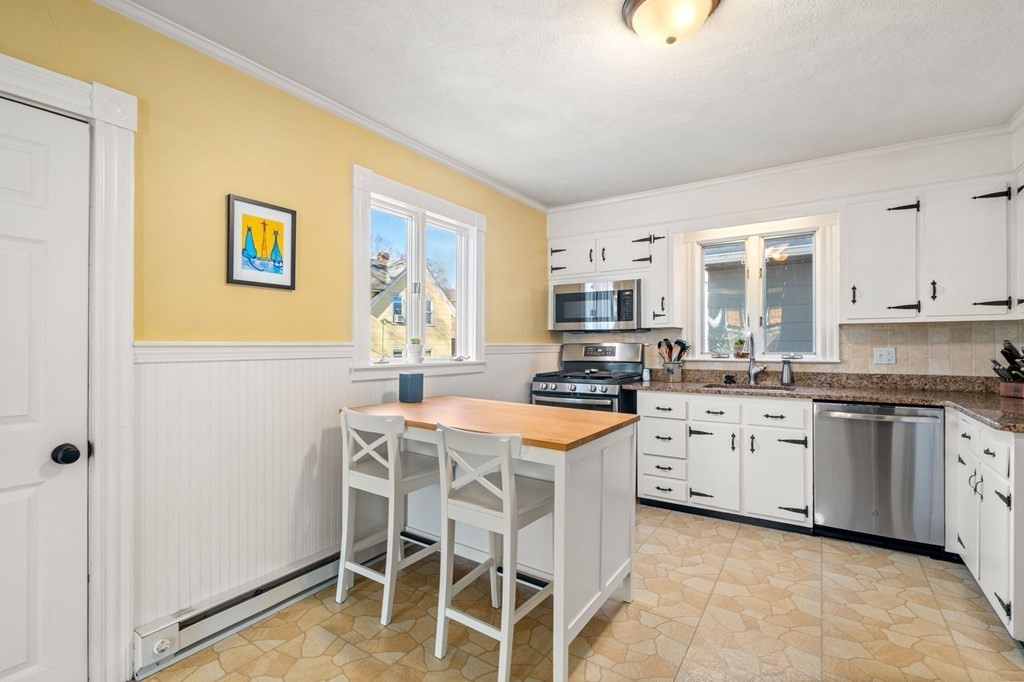 11 Spring Lane Maynard, MA 01754 - Photo 17 of 39 a kitchen with stainless steel appliances granite countertop a stove a sink dishwasher and a refrigerator with wooden cabinets