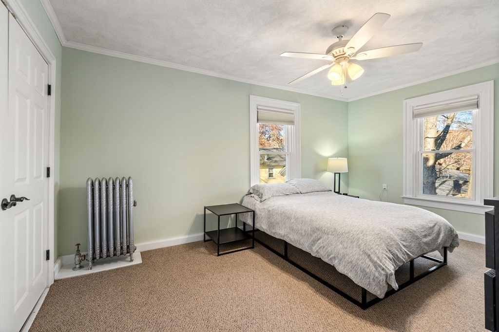 11 Spring Lane Maynard, MA 01754 - Photo 19 of 39 a bedroom with a bed and a chandelier