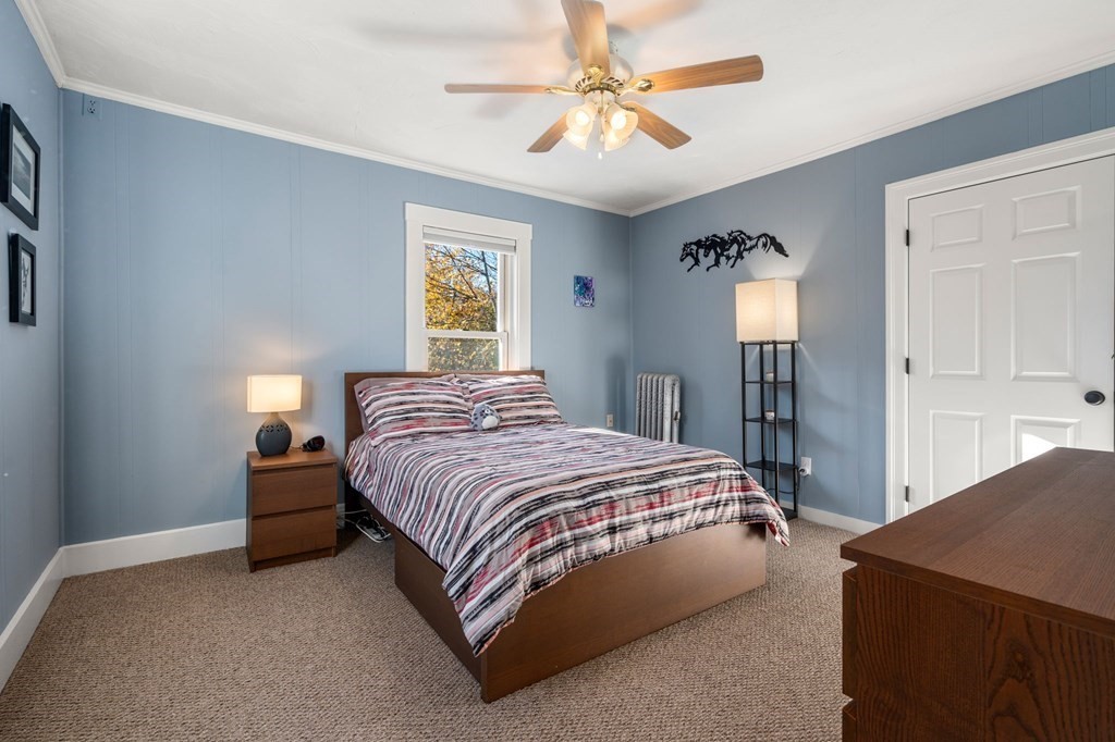 11 Spring Lane Maynard, MA 01754 - Photo 20 of 39 a bedroom with a bed and a chandelier