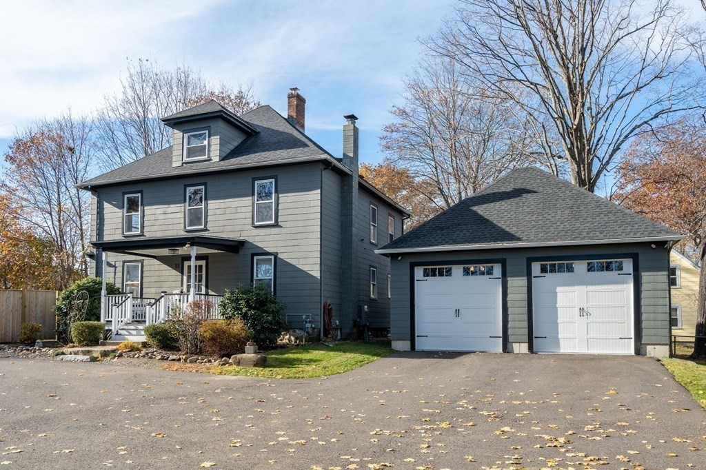 11 Spring Lane Maynard, MA 01754 - Photo 34 of 39 a front view of a house with a yard and garage