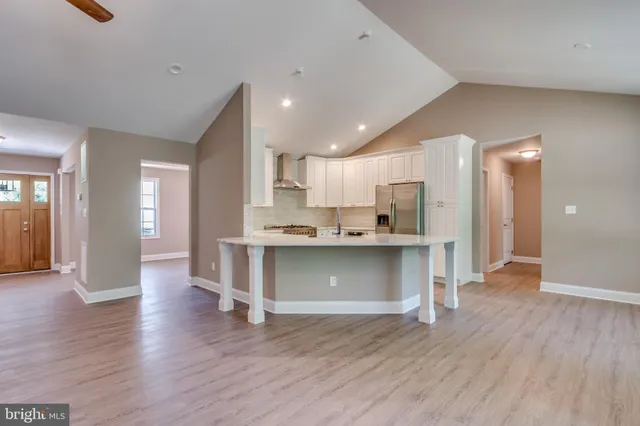 a kitchen with stainless steel appliances granite countertop a refrigerator and a stove