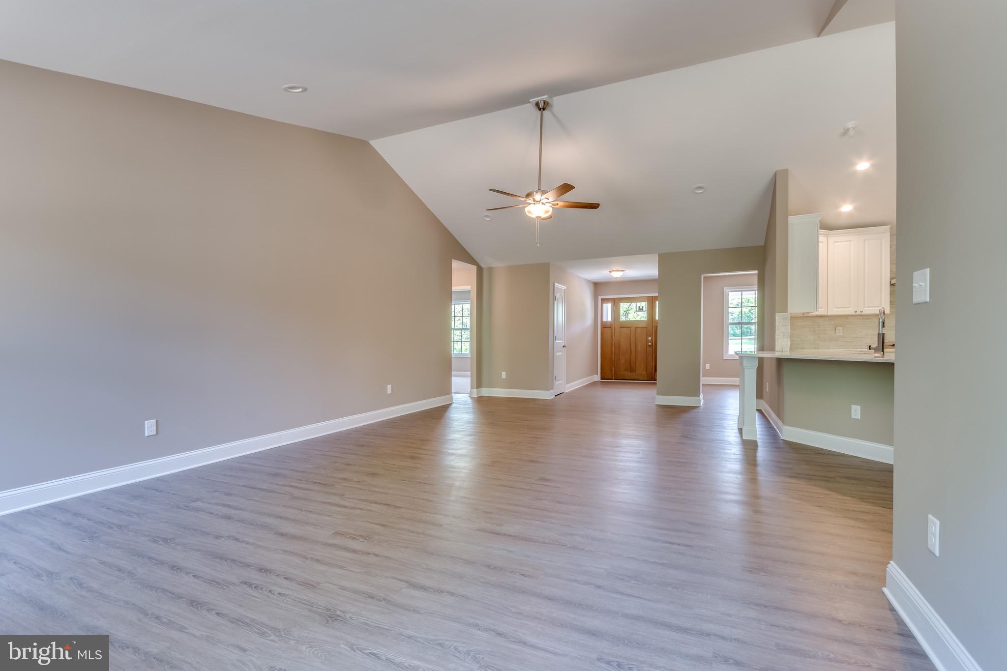 25 Fulton Road Hedgesville, WV 25427 - Photo 12 of 35 a view of an empty room and kitchen with wooden floor