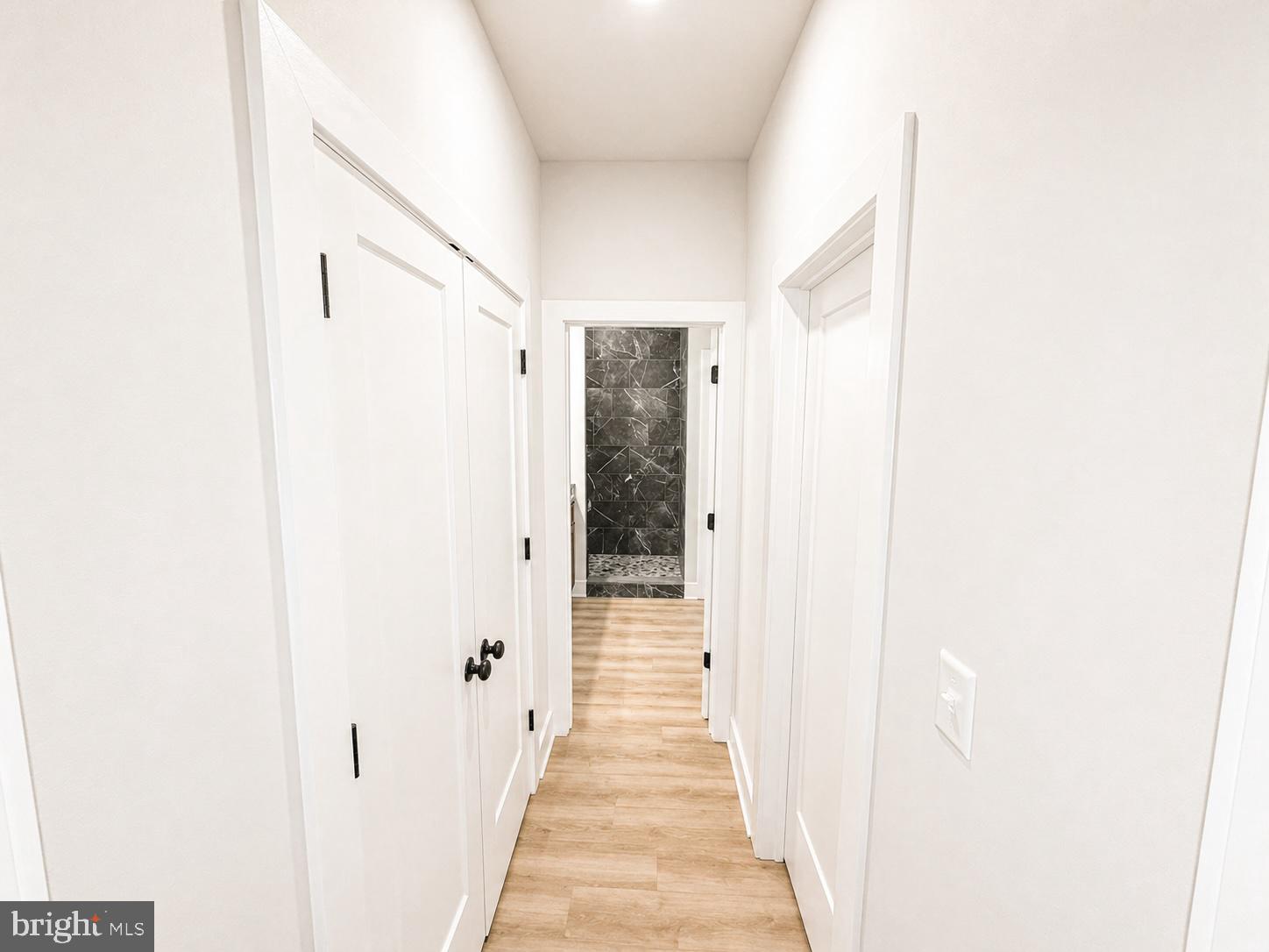 1321 Fulton Road Hedgesville, WV 25427 - Photo 14 of 36 a view of a hallway with wooden floor and a bathroom