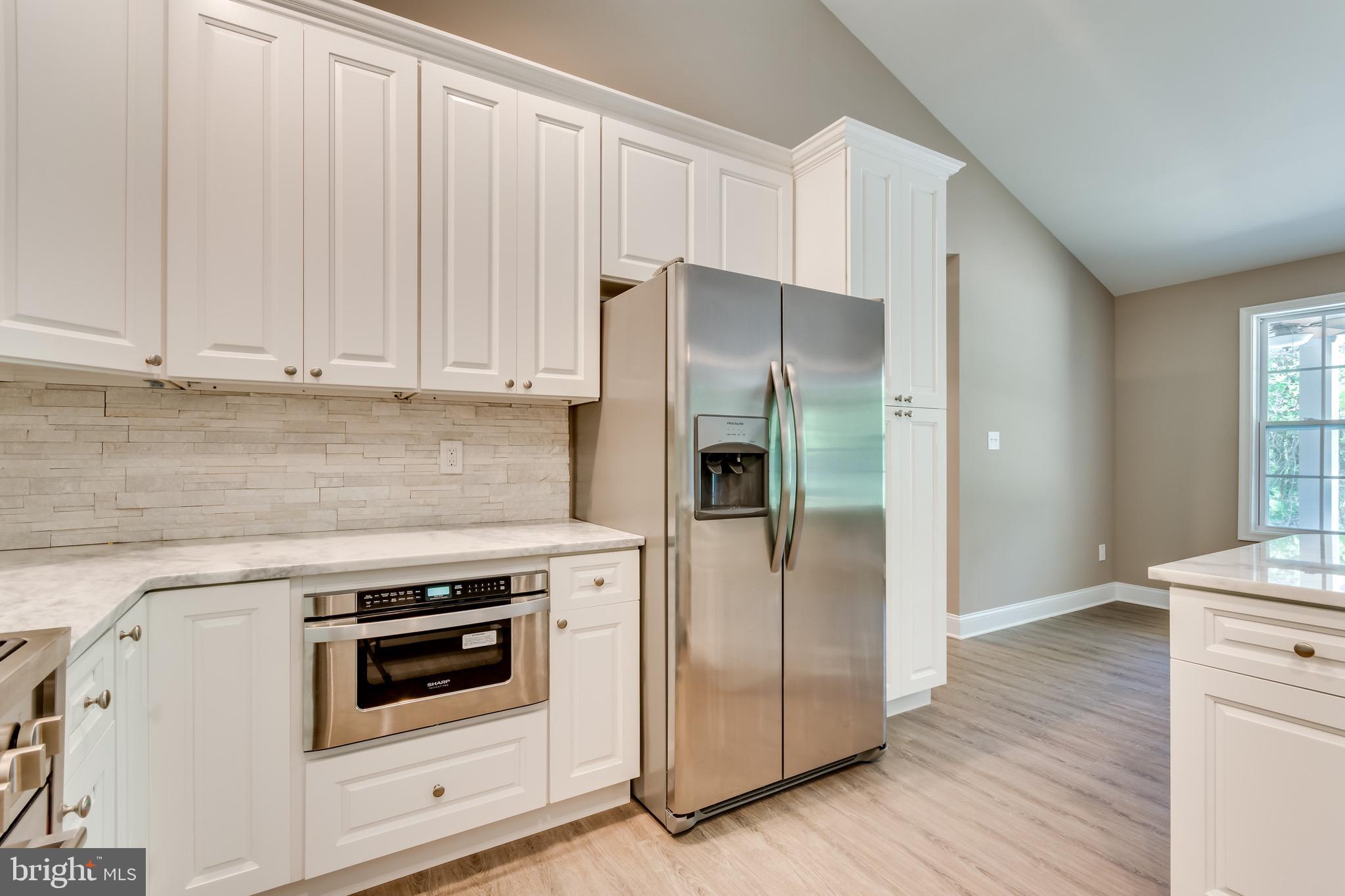 25 Fulton Road Hedgesville, WV 25427 - Photo 15 of 35 a kitchen with white cabinets and white appliances