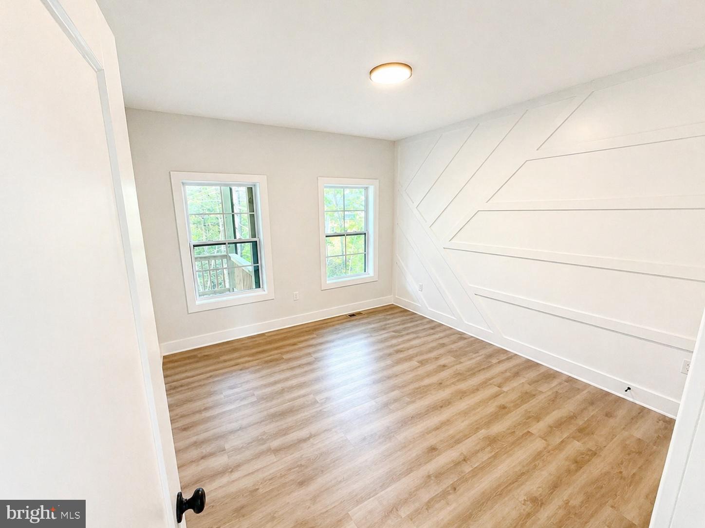 1321 Fulton Road Hedgesville, WV 25427 - Photo 19 of 36 an empty room with wooden floor and windows