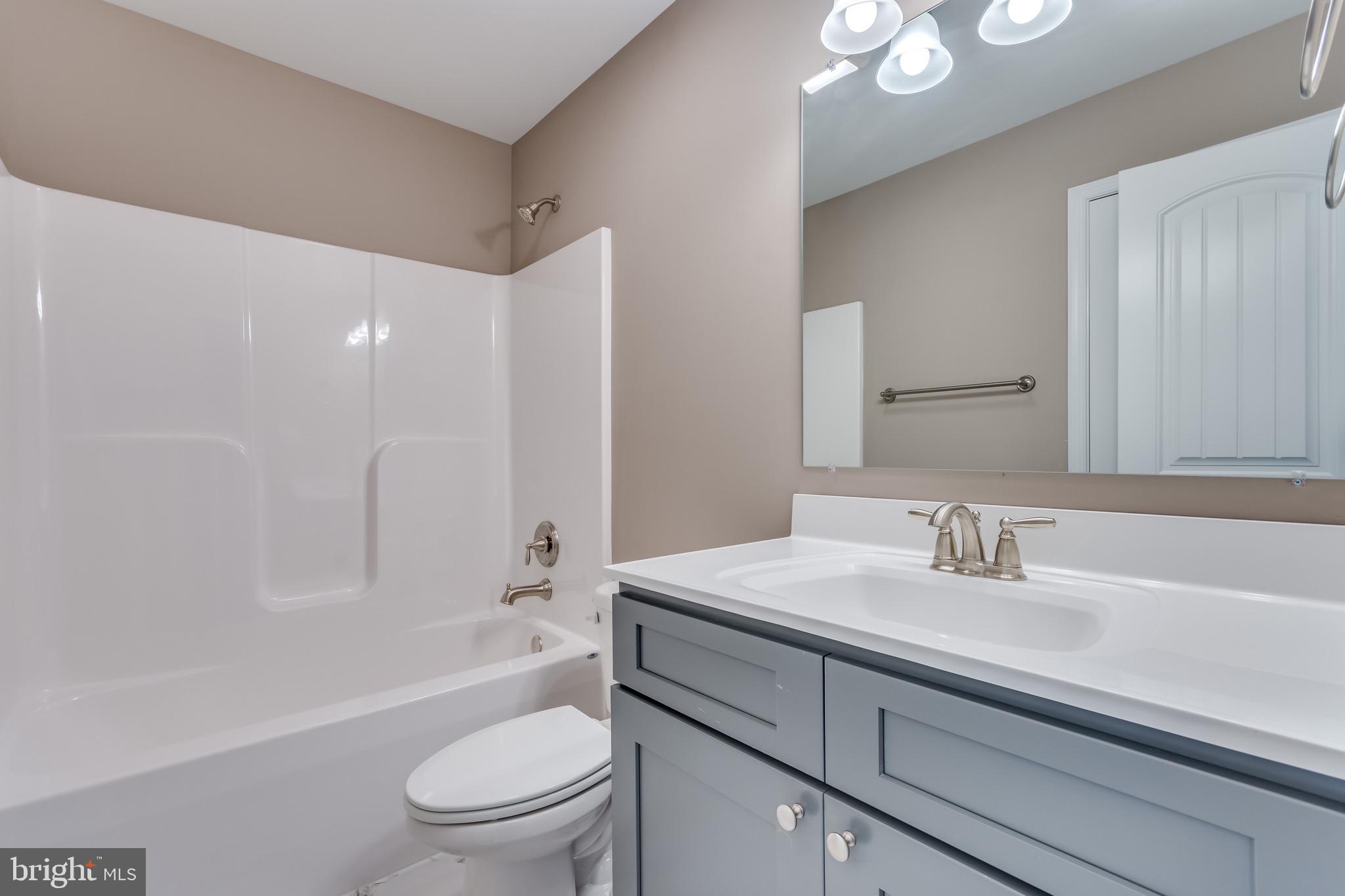 25 Fulton Road Hedgesville, WV 25427 - Photo 22 of 35 a bathroom with a sink a toilet and shower