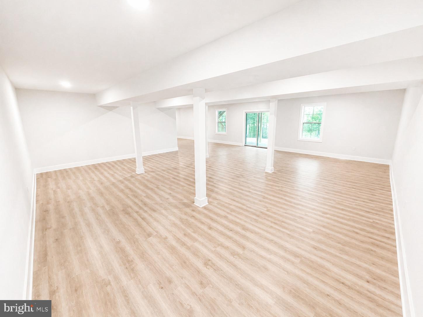 1321 Fulton Road Hedgesville, WV 25427 - Photo 31 of 36 an empty room with wooden floor and windows