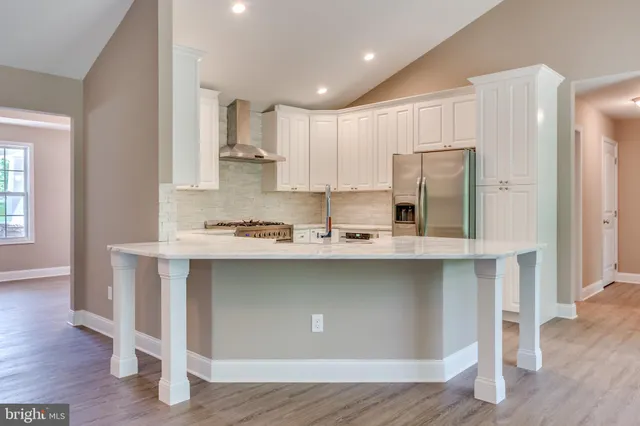 a kitchen with stainless steel appliances a sink and cabinets