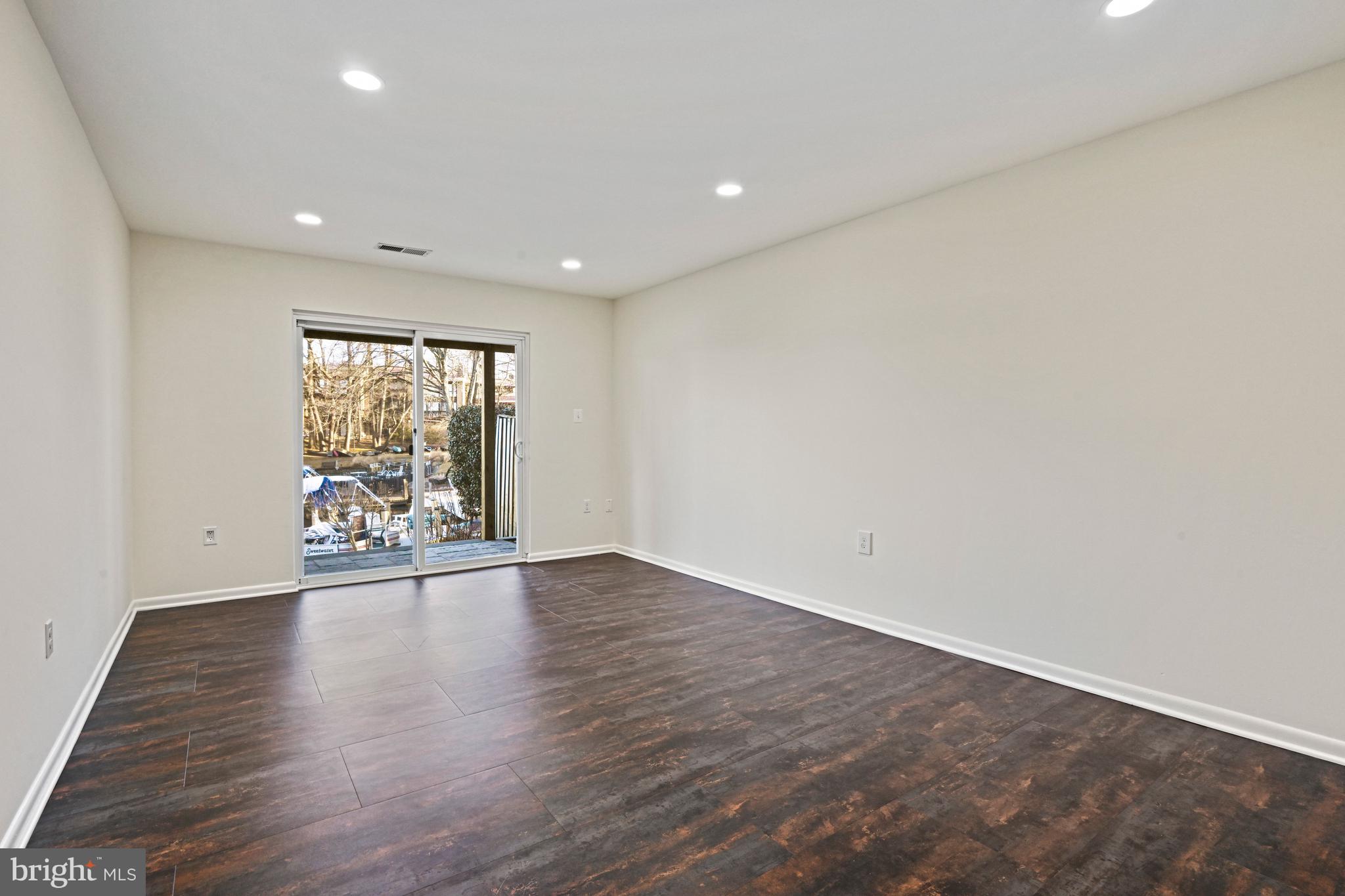 2029 Chadds Ford Drive Reston, VA 20191 - Photo 38 of 55 a view of an empty room with wooden floor and a window