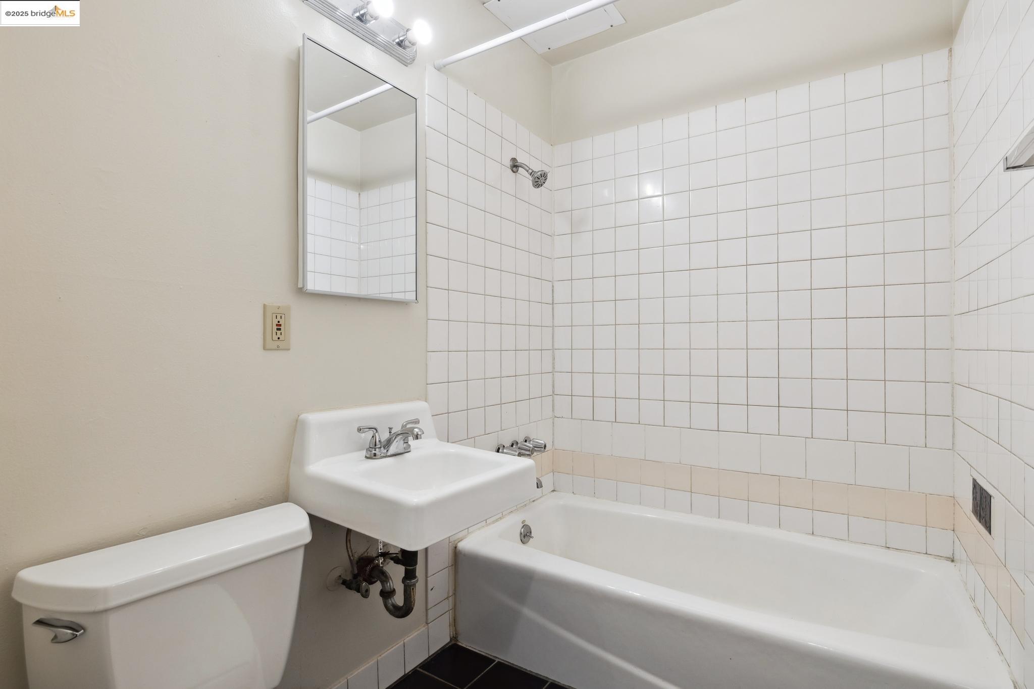 1612 Parker Street Berkeley, CA 94703 - Photo 13 of 16 a bathroom with a sink a toilet and shower