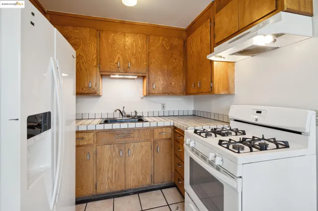 a kitchen with a sink a stove and cabinets