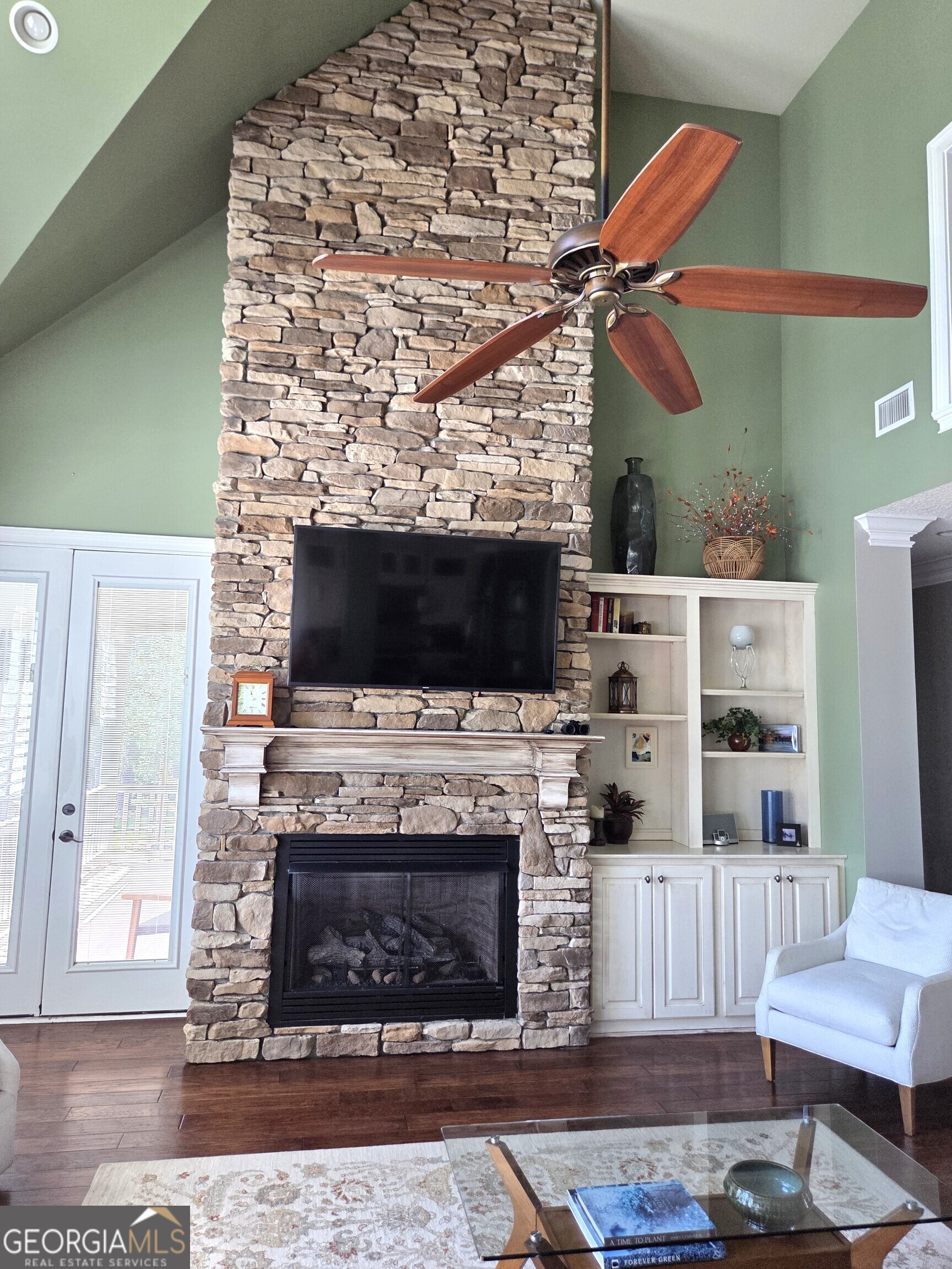 300 Hammond Powell Road Hazlehurst, GA 31539 - Photo 37 of 91 a living room with a fireplace a flat screen tv and a fireplace