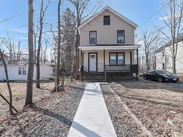 a front view of a house with a yard