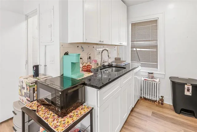 a kitchen with a refrigerator and a stove top oven