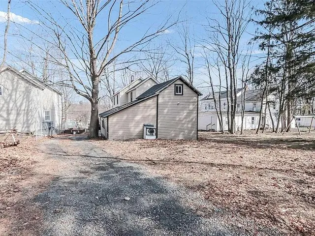 a house that has a tree in front of it