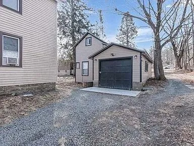 a view of a house with a yard and garage