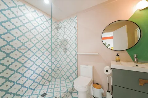 a bedroom with a bed and flat screen tv