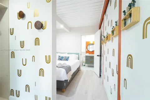 a large bed sitting in a bedroom next to a window