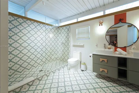 a bathroom with a sink toilet and a mirror