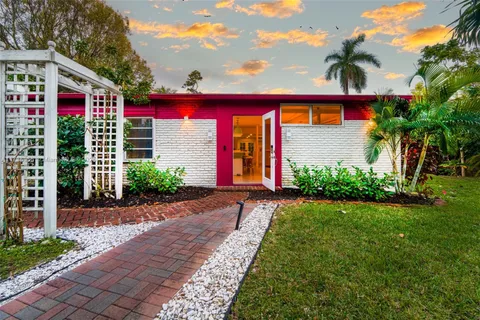 a front view of a house with yard and entryway