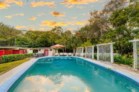 a kitchen with stainless steel appliances granite countertop a kitchen island a stove a table and chairs