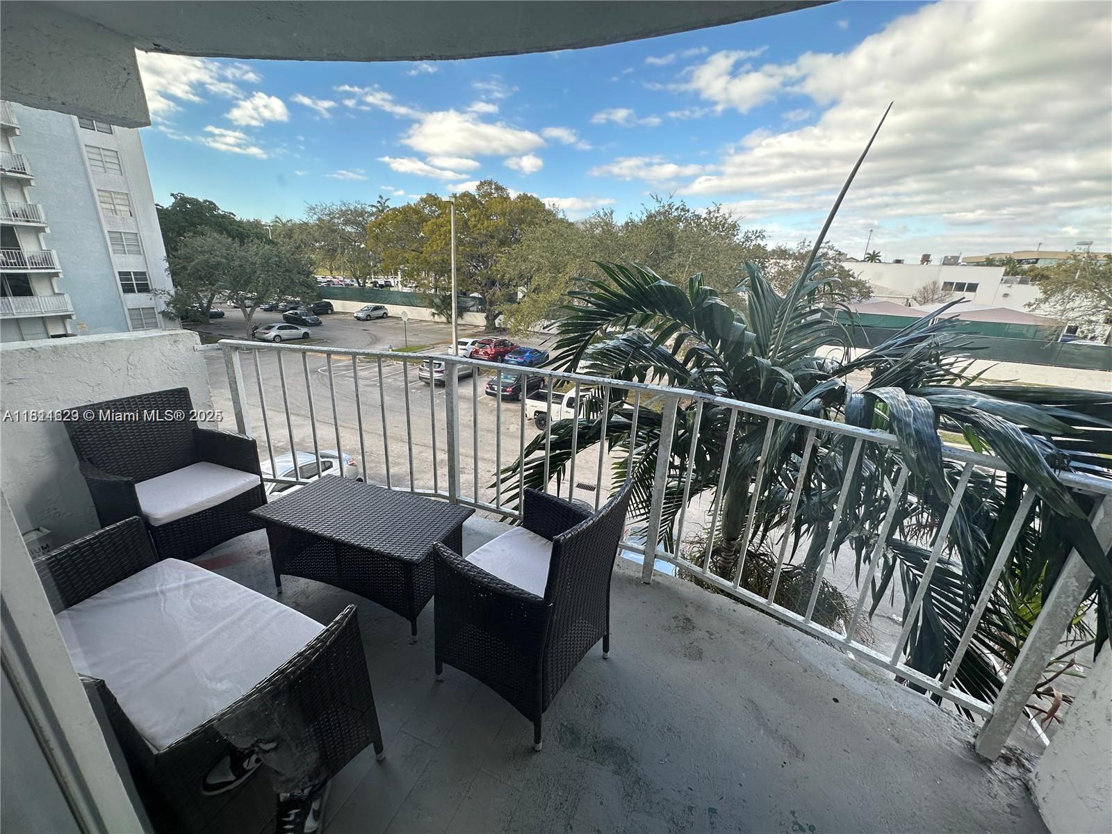 486 Northwest 165th Street, Unit B303 Miami, FL 33169 - Photo 7 of 12 a view of a chairs in a balcony