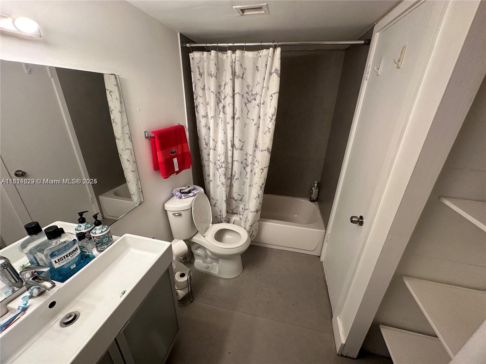 486 Northwest 165th Street, Unit B303 Miami, FL 33169 - Photo 8 of 12 a bathroom with a sink toilet and shower
