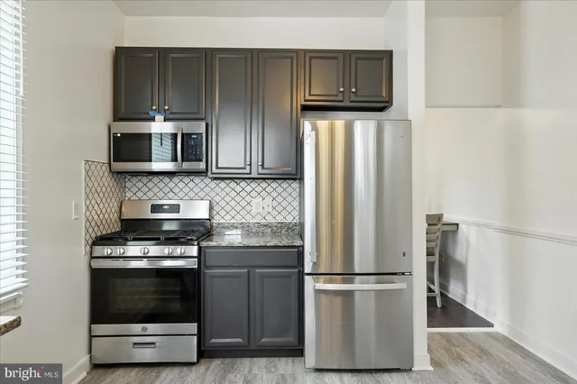 a kitchen with a refrigerator stove and microwave
