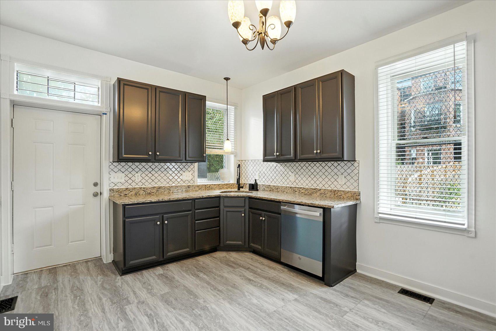 416 Mosher Street Baltimore, MD 21217 - Photo 12 of 38 a kitchen with stainless steel appliances granite countertop wooden cabinets a sink and dishwasher