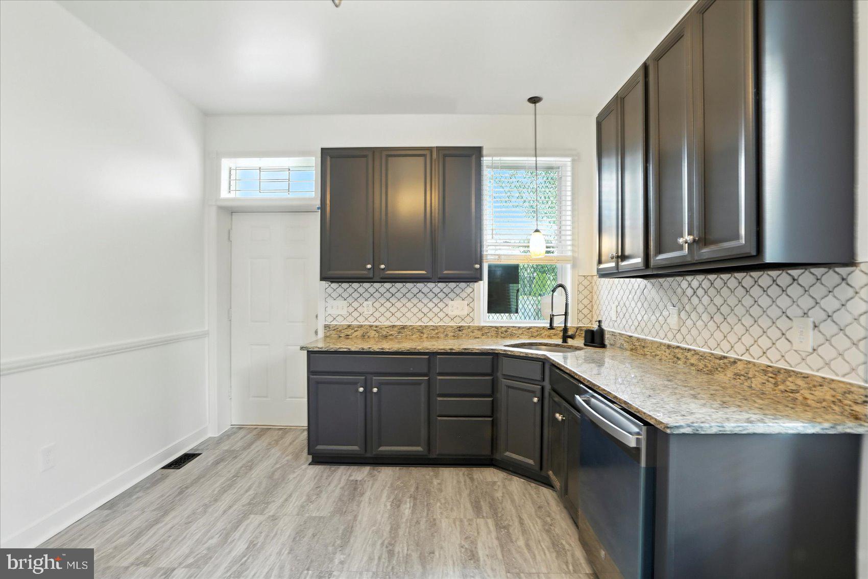 416 Mosher Street Baltimore, MD 21217 - Photo 13 of 38 a kitchen with granite countertop a sink and cabinets
