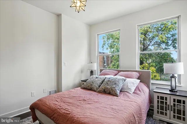 a bedroom with a bed and a television