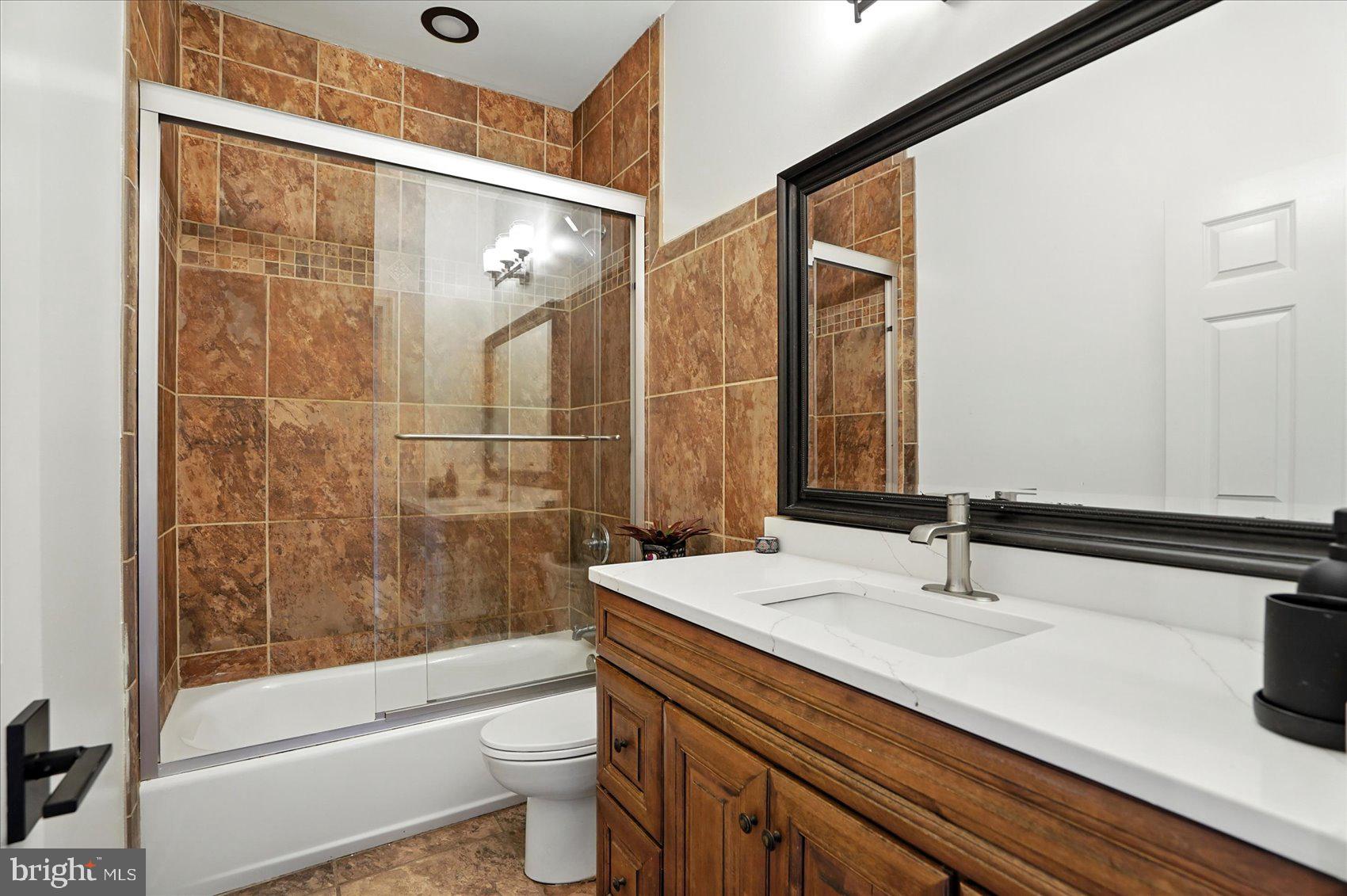 416 Mosher Street Baltimore, MD 21217 - Photo 23 of 38 a bathroom with a sink and a mirror