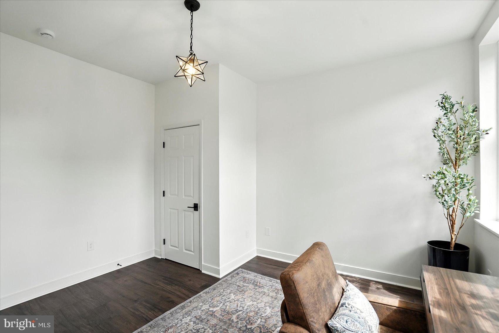 416 Mosher Street Baltimore, MD 21217 - Photo 26 of 38 a view of a livingroom with a potted plant a ceiling fan and a window