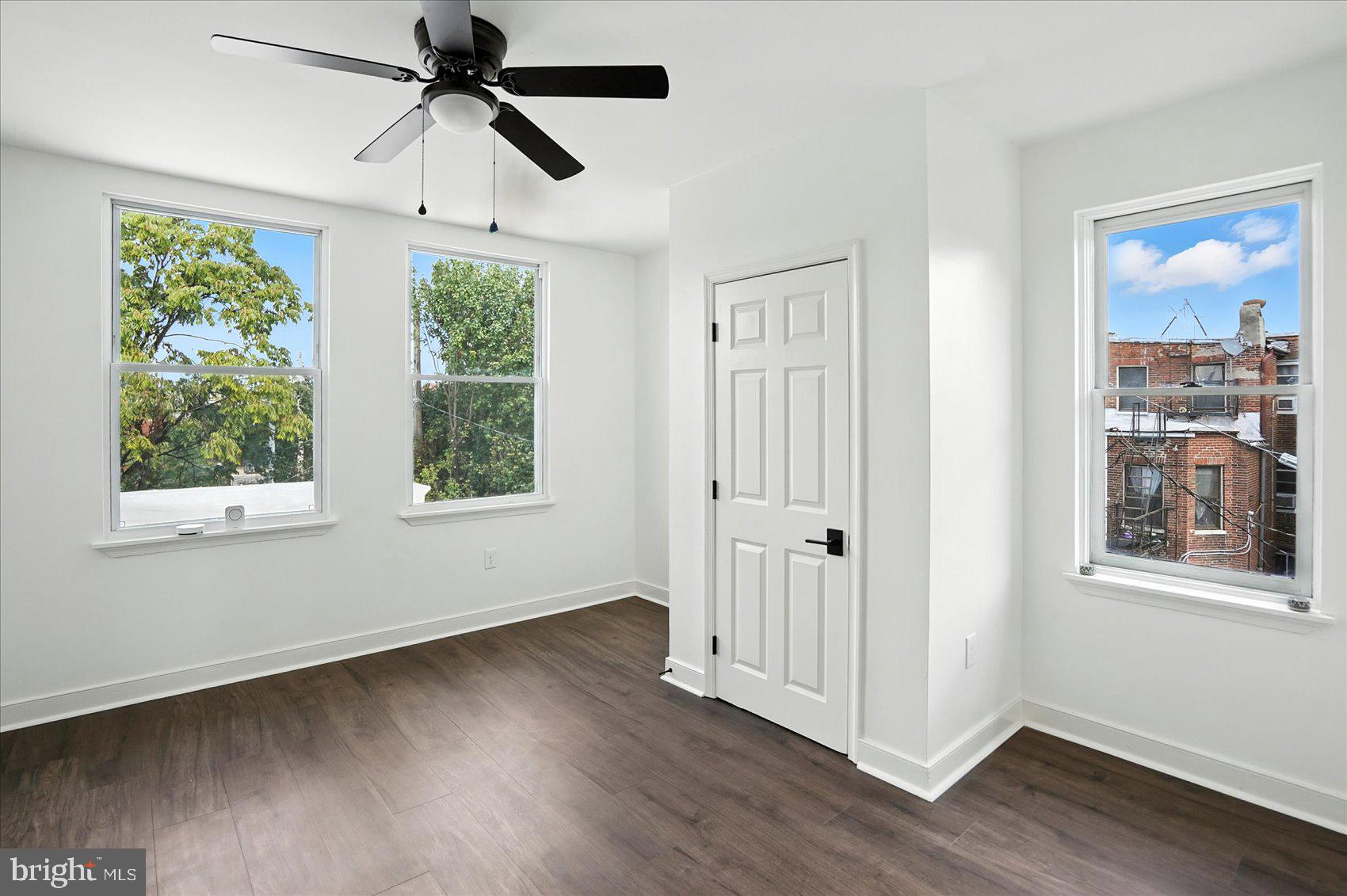 416 Mosher Street Baltimore, MD 21217 - Photo 32 of 38 a view of an empty room with wooden floor and a window