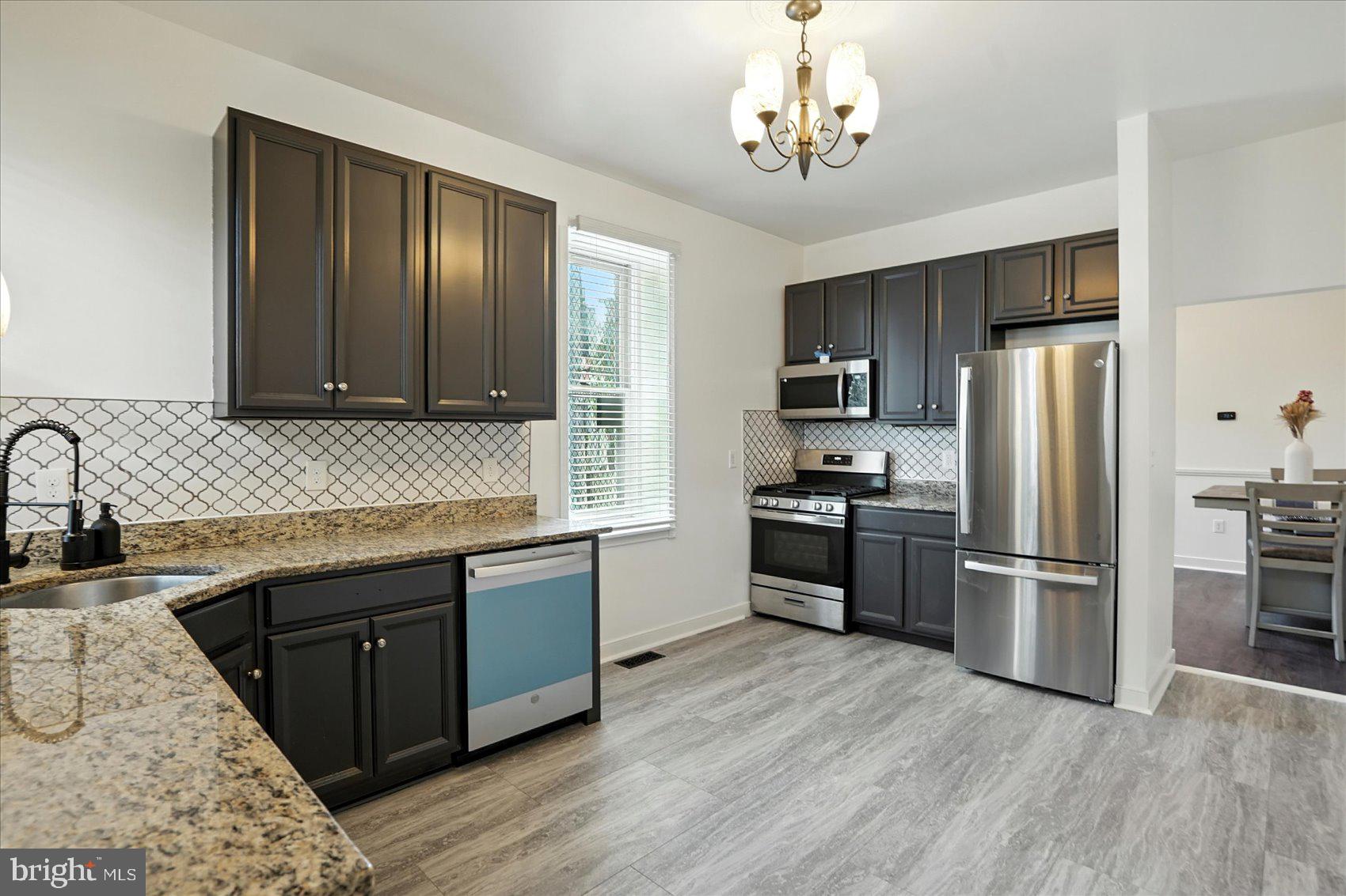 416 Mosher Street Baltimore, MD 21217 - Photo 10 of 38 a kitchen with stainless steel appliances granite countertop a refrigerator stove and sink