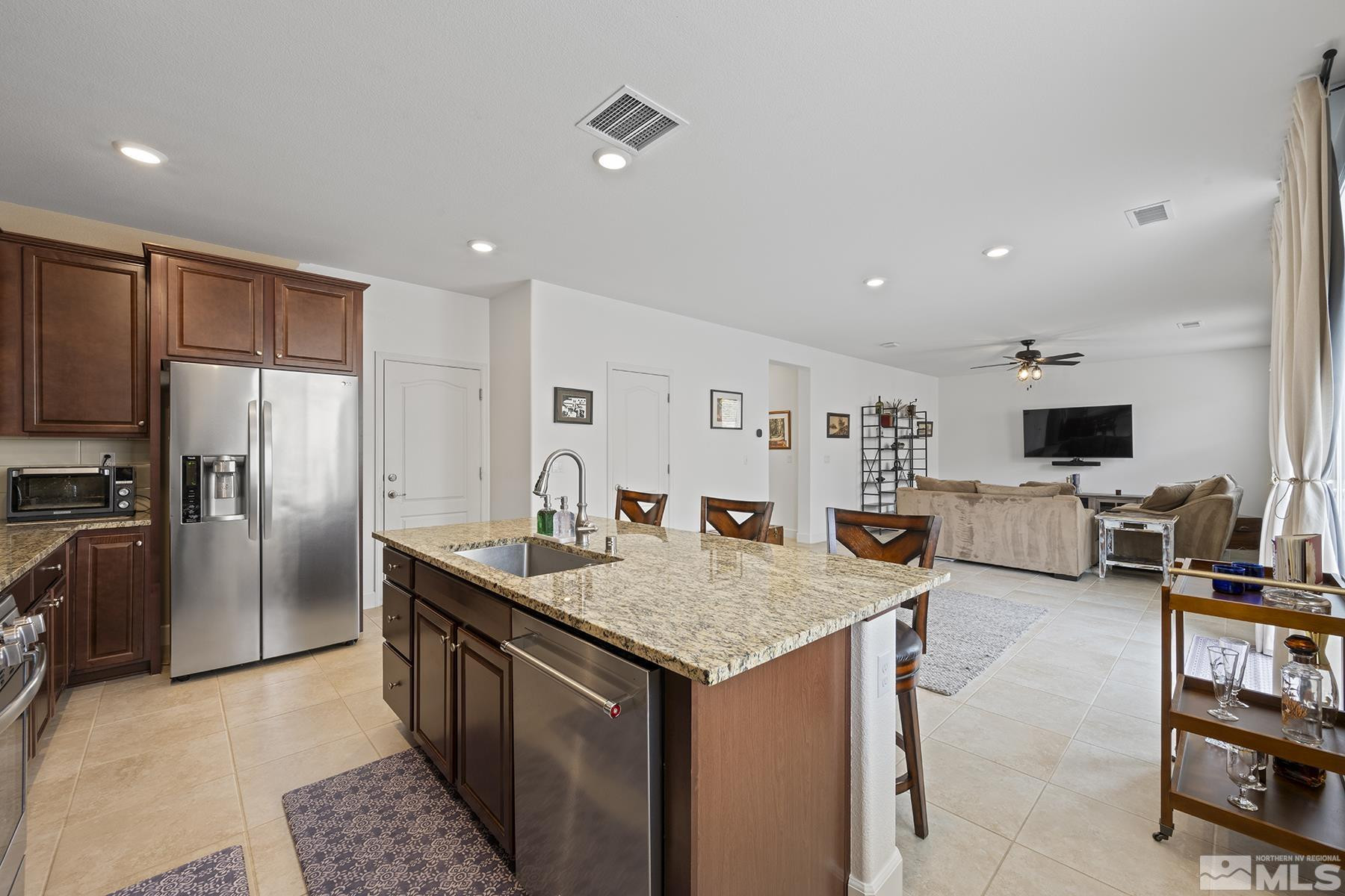 10370 Gold Mine Drive Reno, NV 89521 - Photo 6 of 31 a kitchen with stainless steel appliances granite countertop a sink a stove and a refrigerator