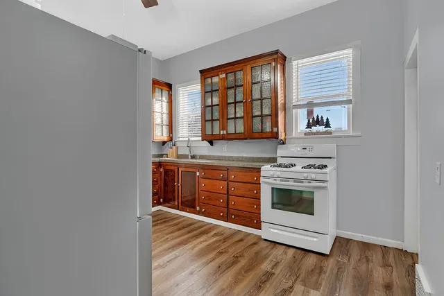 a kitchen with stainless steel appliances granite countertop a stove and a sink
